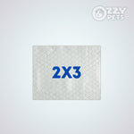 A square, light gray textured mat with a diamond pattern and the blue text '2X3' in the center, shown on a light gray background with an 'OZZY PETS' logo in the top right corner.