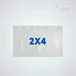 A rectangular white quilted pet mat with a diamond pattern and the blue text '2X4' in the center, shown on a light gray background with the 'OZZY PETS' logo in the top right corner.
